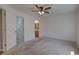 Clean bedroom features a ceiling fan, plush carpet and an ensuite bathroom at 20194 Robins Dr, Denver, CO 80249