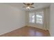 Sunny bedroom with wood floors, ceiling fan, and two bright windows overlooking the neighborhood at 20194 Robins Dr, Denver, CO 80249