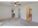 Spacious bedroom with neutral carpet, ceiling fan and ensuite bath with walk-in shower at 20194 Robins Dr, Denver, CO 80249