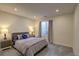 Bright carpeted bedroom features egress window, two side tables, and a comfortable bed at 20194 Robins Dr, Denver, CO 80249