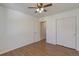 Bedroom with wood floors, ceiling fan and a closet with mirrored sliding doors at 20194 Robins Dr, Denver, CO 80249