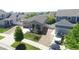 Well-maintained home showcasing curb appeal with mature landscaping and a two-car garage at 20194 Robins Dr, Denver, CO 80249