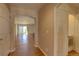 Hallway with wood floors leading to the living room and a separate laundry area at 20194 Robins Dr, Denver, CO 80249