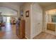 Hallway with hardwood floors, wooden display case, and access to the living room at 20194 Robins Dr, Denver, CO 80249