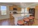 Bright kitchen boasts stainless steel appliances, light wood cabinets and an island with seating at 20194 Robins Dr, Denver, CO 80249