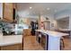 Bright kitchen featuring an island with bar seating, stainless steel appliances, and lots of cabinet space at 20194 Robins Dr, Denver, CO 80249