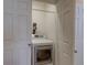 Modern white front load washer and dryer in hall laundry closet at 20194 Robins Dr, Denver, CO 80249