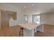Open concept living room with breakfast bar, hardwood floors and lots of natural light at 20194 Robins Dr, Denver, CO 80249