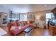 Well-decorated living room featuring a comfortable sectional sofa, shelving, and lots of natural light at 20194 Robins Dr, Denver, CO 80249