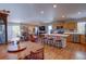 Open-concept floor plan with a kitchen island, dining area, and spacious living room with lots of natural light at 20194 Robins Dr, Denver, CO 80249
