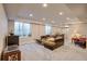 Finished basement living room offers recessed lighting, large couch, and egress window at 20194 Robins Dr, Denver, CO 80249