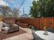 Private backyard with stone patio, string lights, mature trees, and raised garden bed at 3914 Osage St, Denver, CO 80211