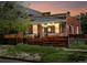Charming brick home with string lights, a wooden fence, and a cozy front porch at sunset at 3914 Osage St, Denver, CO 80211