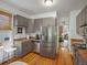 Efficient kitchen with stainless steel appliances and warm, wood-toned floors at 3914 Osage St, Denver, CO 80211