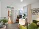 Stylish living room with a peek into the kitchen and a comfortable green sofa at 3914 Osage St, Denver, CO 80211