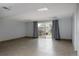 Basement space with tile flooring, sliding glass doors to the yard, and neutral walls at 12631 W Dakota Dr, Lakewood, CO 80228
