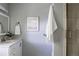 Neutral bathroom features a single sink vanity with a shower and framed art at 12631 W Dakota Dr, Lakewood, CO 80228