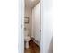 View of the bathroom including a toilet, shower with a white curtain, and a decorative landscape art piece at 12631 W Dakota Dr, Lakewood, CO 80228
