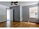 Spacious bedroom with hardwood floors, large windows, a ceiling fan, and a doorway to another room at 12631 W Dakota Dr, Lakewood, CO 80228