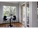 Bright breakfast nook with hardwood floors, a bistro table, and sliding doors to the home's exterior at 12631 W Dakota Dr, Lakewood, CO 80228