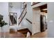 Inviting entryway with hardwood floors, staircase, and a view into the adjacent kitchen area at 12631 W Dakota Dr, Lakewood, CO 80228