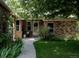 Charming brick home featuring a covered front porch, well-maintained landscaping, and a welcoming walkway at 12631 W Dakota Dr, Lakewood, CO 80228