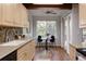 Bright kitchen featuring modern appliances, a breakfast nook, and access to an outdoor balcony at 12631 W Dakota Dr, Lakewood, CO 80228