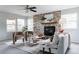 Bright living room featuring a stone fireplace, neutral furniture, and large windows for natural light at 12631 W Dakota Dr, Lakewood, CO 80228