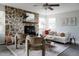 Stylish living room with a stone fireplace, comfortable seating, and an open, airy ambiance at 12631 W Dakota Dr, Lakewood, CO 80228