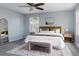 Stylish main bedroom with a plush king bed, neutral decor, and windows overlooking the lush yard at 12631 W Dakota Dr, Lakewood, CO 80228
