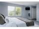 Comfortable main bedroom with carpet, large windows for natural light, and a mounted TV at 12631 W Dakota Dr, Lakewood, CO 80228