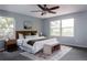 Sun-filled main bedroom with a plush king bed, neutral decor, and windows overlooking the lush yard at 12631 W Dakota Dr, Lakewood, CO 80228
