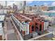 Aerial view of a modern townhome community with rooftop patios and city views at 2350 Tremont Pl # 13, Denver, CO 80205
