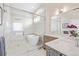 Spa-like bathroom with a frameless glass shower, soaking tub, and double sink vanity at 2350 Tremont Pl # 13, Denver, CO 80205