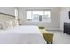 Spacious main bedroom with plush bedding and city view at 2350 Tremont Pl # 13, Denver, CO 80205