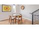 Cozy dining area featuring a glass table, modern lighting, and hardwood floors at 2350 Tremont Pl # 13, Denver, CO 80205