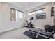 Bright home gym complete with modern exercise equipment and a wall-mounted television at 2350 Tremont Pl # 13, Denver, CO 80205
