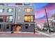 Modern townhome with a gray and red exterior, large windows, and a small front yard at 2350 Tremont Pl # 13, Denver, CO 80205