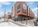 Modern townhome exterior with attached garage and brick accents at 2350 Tremont Pl # 13, Denver, CO 80205