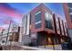 Modern three-story townhouse showcases unique architectural details, multi-tone color scheme, and a private fenced yard at 2350 Tremont Pl # 13, Denver, CO 80205