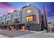 Contemporary townhomes with sleek design, multiple windows, and well-maintained landscaping on a tree-lined street at 2350 Tremont Pl # 13, Denver, CO 80205