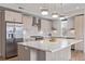 Modern kitchen with stainless steel appliances, a large center island, and designer lighting at 2350 Tremont Pl # 13, Denver, CO 80205