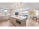 Open kitchen with island, modern appliances, hardwood floors, and seamless flow to living spaces at 2350 Tremont Pl # 13, Denver, CO 80205