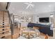 Bright, open-concept living room with modern finishes, staircase, and stylish furnishings at 2350 Tremont Pl # 13, Denver, CO 80205
