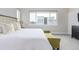 Sunlit main bedroom featuring plush bedding, stylish accents, and a tranquil atmosphere at 2350 Tremont Pl # 13, Denver, CO 80205