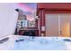 Relaxing rooftop featuring a luxurious hot tub with city views in the background at 2350 Tremont Pl # 13, Denver, CO 80205