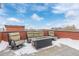 Rooftop deck with fire pit and comfortable seating at 2350 Tremont Pl # 13, Denver, CO 80205