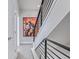 Modern staircase with striking metal railings and a vibrant art piece at 2350 Tremont Pl # 13, Denver, CO 80205