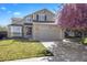 Spacious backyard showcasing a fire pit and lush green lawn, perfect for outdoor gatherings at 13846 Harrison Dr, Thornton, CO 80602