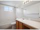 Well-lit bathroom offers a single sink vanity, a bath tub, and a shower head at 13846 Harrison Dr, Thornton, CO 80602